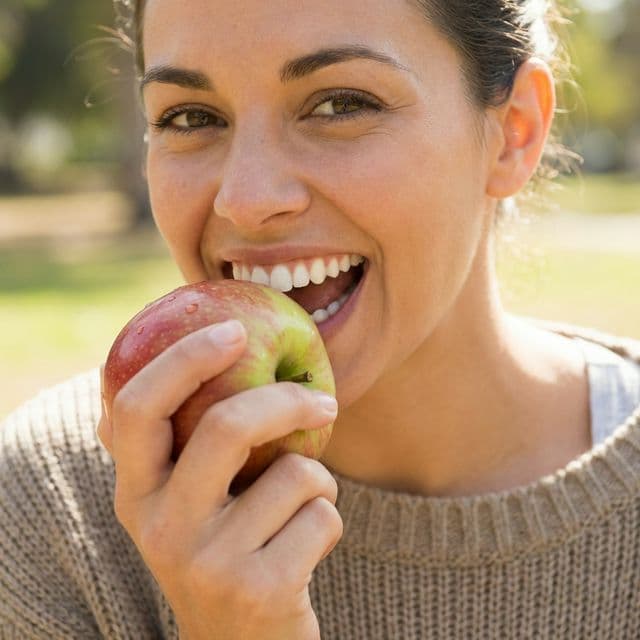 Woman enjoying coffee after chipped tooth bonding repair at Innova Smiles in Marlborough, MA