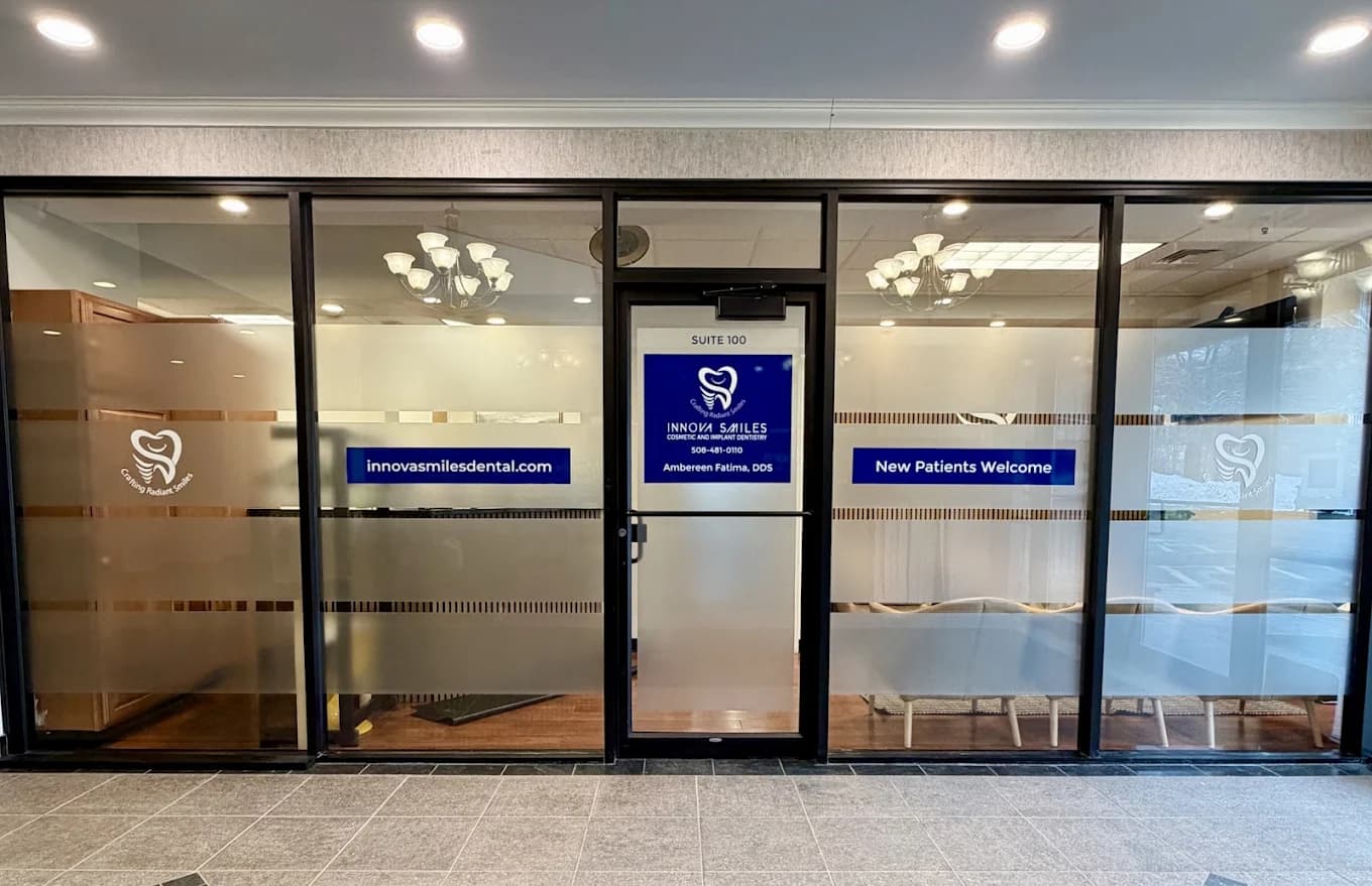 Glass storefront of Innova Smiles, Suite 100, at 340 Maple St, Marlborough, with the practice name and Ambereen Fatima, DDS on the door