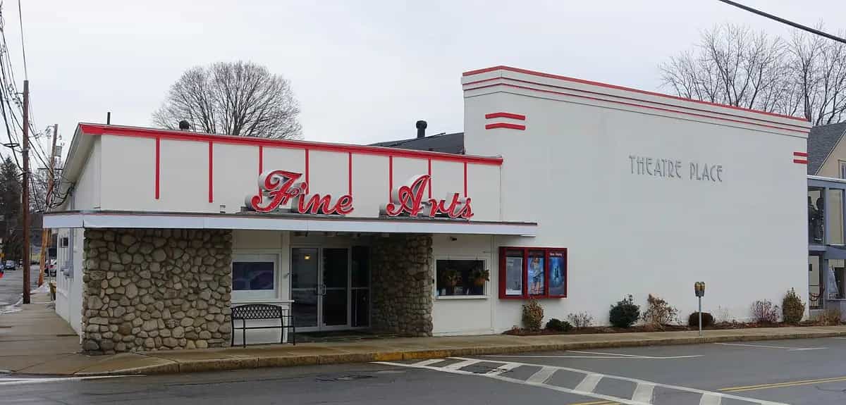 The restored Fine Arts Theatre Place with its bright red Art Deco marquee and fieldstone base on Main Street in downtown Maynard, Massachusetts