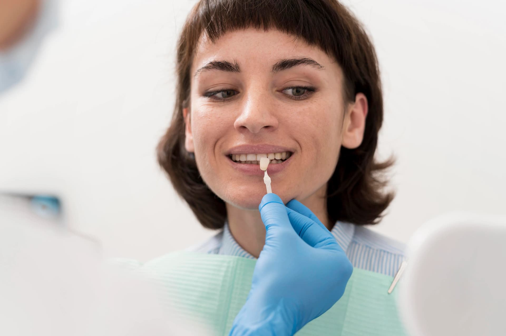 Teen celebrating aligned, bright smile after Invisalign treatment